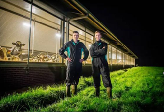 Two young farmers in front of their farm