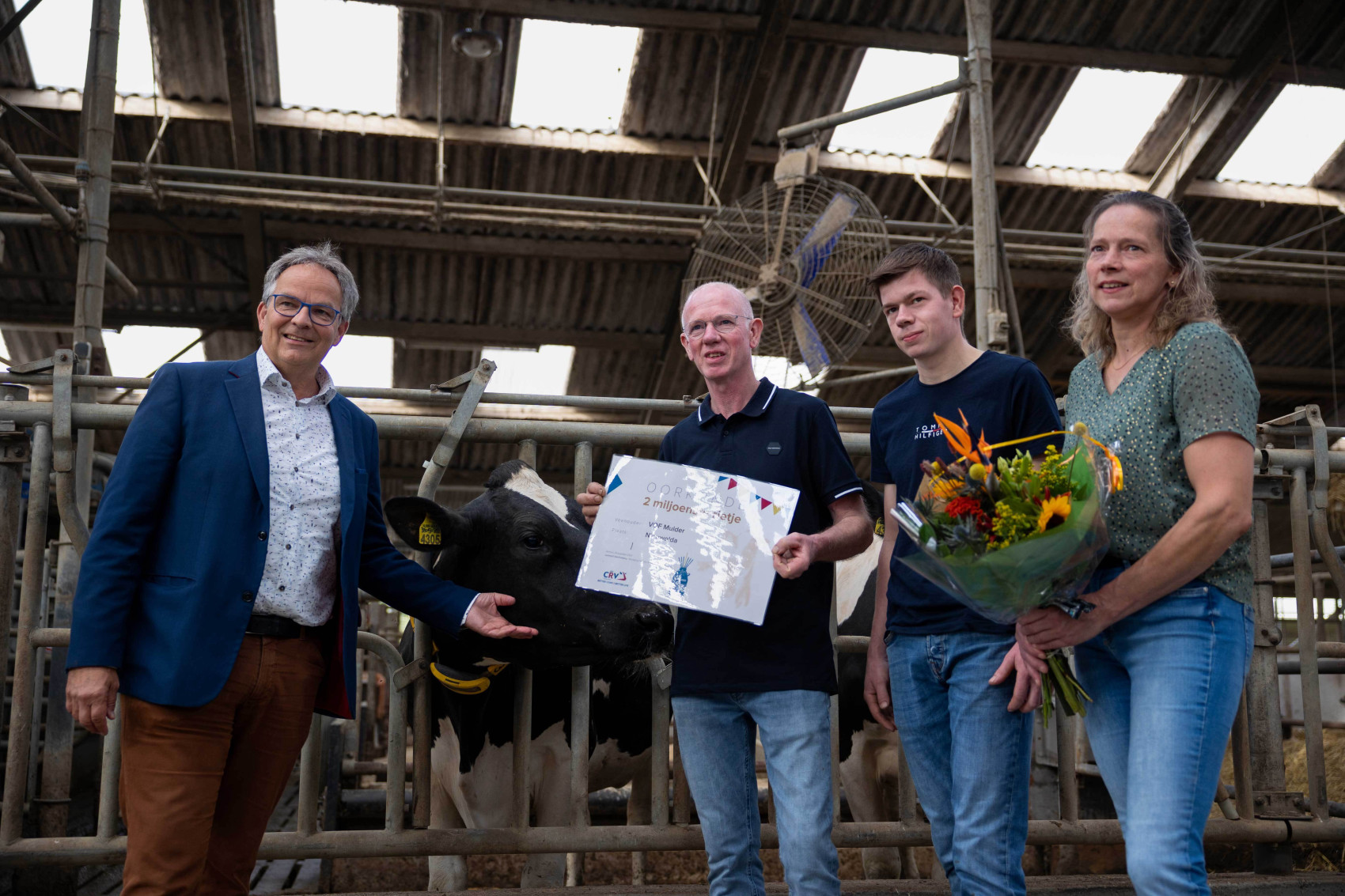 Director CRV and farmers in a barn celebration 2 mlnth. straw semen